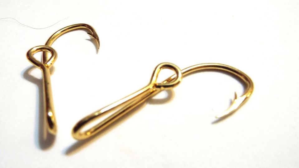 Two gold fish hooks.
